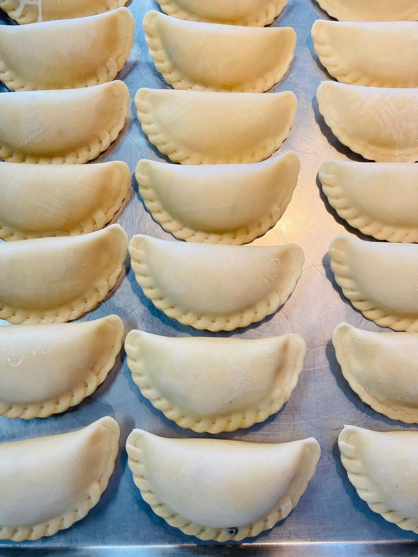 Actual uncooked Empanada Sonata batches arranged for production